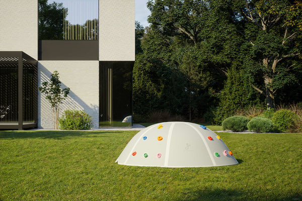 Modern garden with Jupiduu outdoor climbing dome – minimalist white kids’ climbing structure with colourful grips for active outdoor play