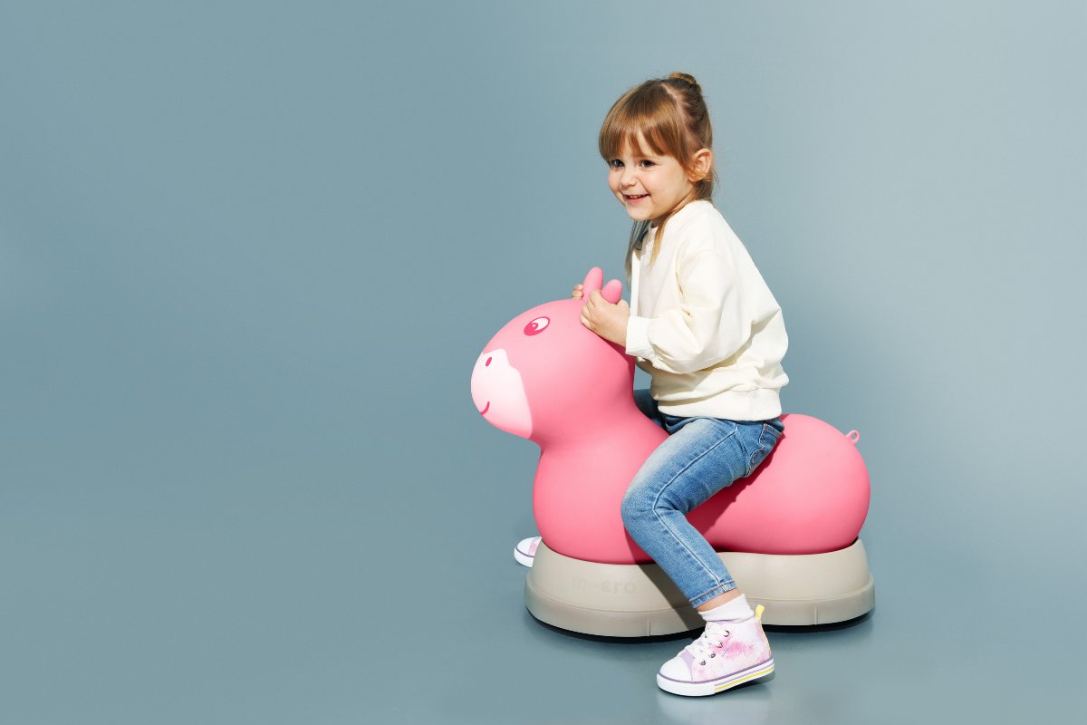 A happy child enjoys bouncing on the Micro Rody Deluxe ride-on toy, a playful and durable companion for active toddlers. The soft, stable base provides a safe and fun experience for endless indoor adventures.