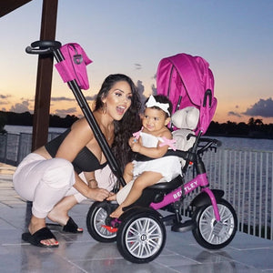Celebrity Carissa Rosario and her daughter enjoying a sunset ride on the Bentley 6-in-1 Trike in fuchsia pink, styled for luxury and comfort.