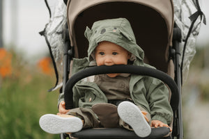 Baby in stroller with cute animal hoodie, enjoying outdoor adventure – Little Gliders comfortable strollers.