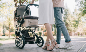 Parents with luxury stroller on park path – stylish prams by Little Gliders for modern families