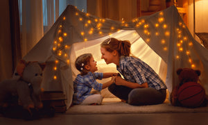 Mother and child bonding in cozy tent with fairy lights – Little Gliders inspiring magical family moments at home