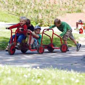Children playing with red Gonge group trike – collaborative outdoor ride-on toy for early years settings