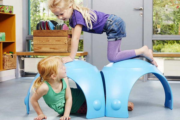 Two kids playing on blue gonge toy