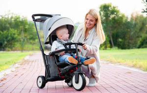 Mother interacting with child seated in smarTrike stroller trike - ideal for family walks and bonding time by Little Gliders