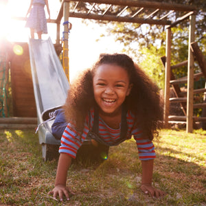 Happy child playing outdoors on slide – Little Gliders 3-6 year collection