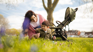 Mother and child enjoying the outdoors with the Didofy Aster 2 stroller, highlighting its portable and convenient foldable design.