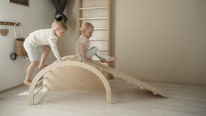 FitWood TUOHI Slide in birch wood for kids, designed to promote active play and enhance motor skills. Two Children playing with slide with Climbing arch, one climbing and one sliding down