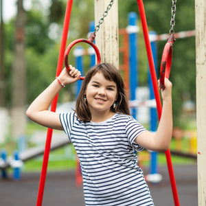 Smiling girl on playground rings – Little Gliders 10+ year collection