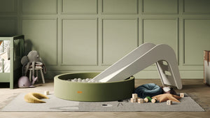 Elegant playroom featuring the Jupiduu ball pit and slide set in olive green, perfect for indoor fun and sensory development – available at Little Gliders.