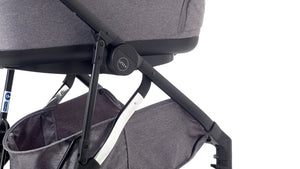 Close-up of the Mee-go Uno+ pushchair frame and bassinet with under-seat storage visible.