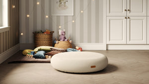 Round nursery pouf surrounded by colourful toys and cozy decor in a stylish, playful room setup for toddlers. Jupiduu at Little Gliders