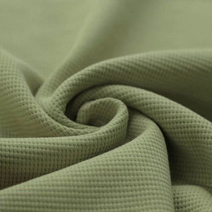 Close-up of soft olive green waffle fabric, showcasing its textured surface and durable quality for various uses – available at Little Gliders. Ball Pit Jupiduu