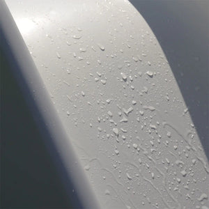 Close-up of the outdoor slide's water-resistant ABS plastic surface with rain droplets, showing weatherproof durability for year-round garden play.